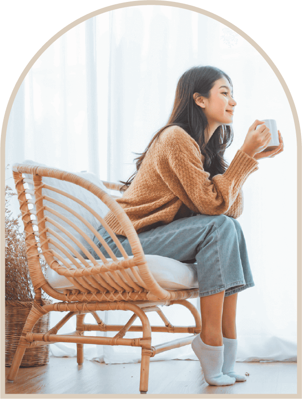 椅子に座ってカップを持つ女性