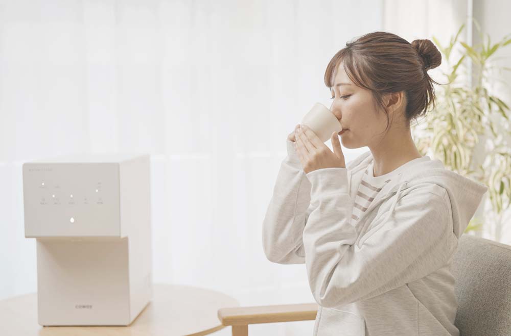 ウォータースタンドと水を飲む女性